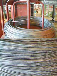 Deformed rebar wire coils on wire stand to unload. The rebar wire draw by vertical deformed wire drawing machine.